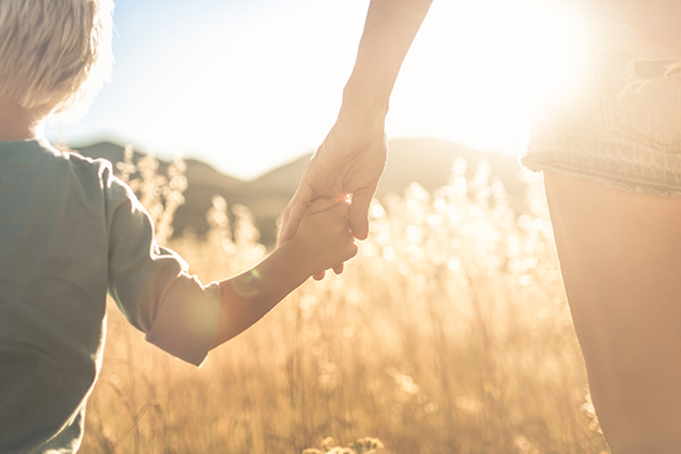 Mom holding child's hand